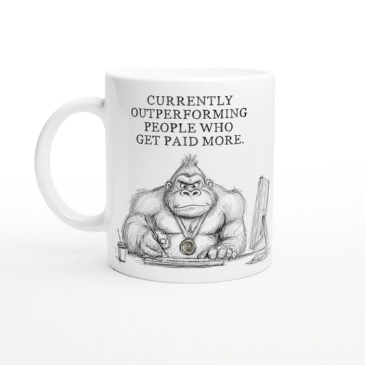 White mug featuring a pencil sketch of a muscular gorilla at a desk, wearing a medal; slogan: Currently outperforming people.