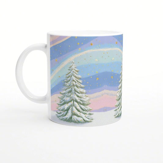 White mug featuring a pastel winter landscape: snow-covered evergreens, layered blue-pink sky, and gold flecks.