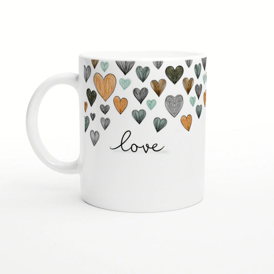 White ceramic mug with a hand-drawn hearts pattern in orange, teal, and gray, and the word love in cursive.