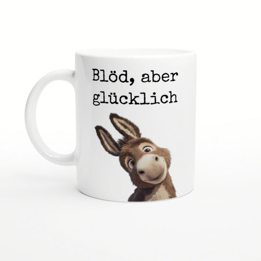 White ceramic mug mockup with black typewriter-style text Blöd, aber glücklich and a cartoon donkey peeking from the bottom.