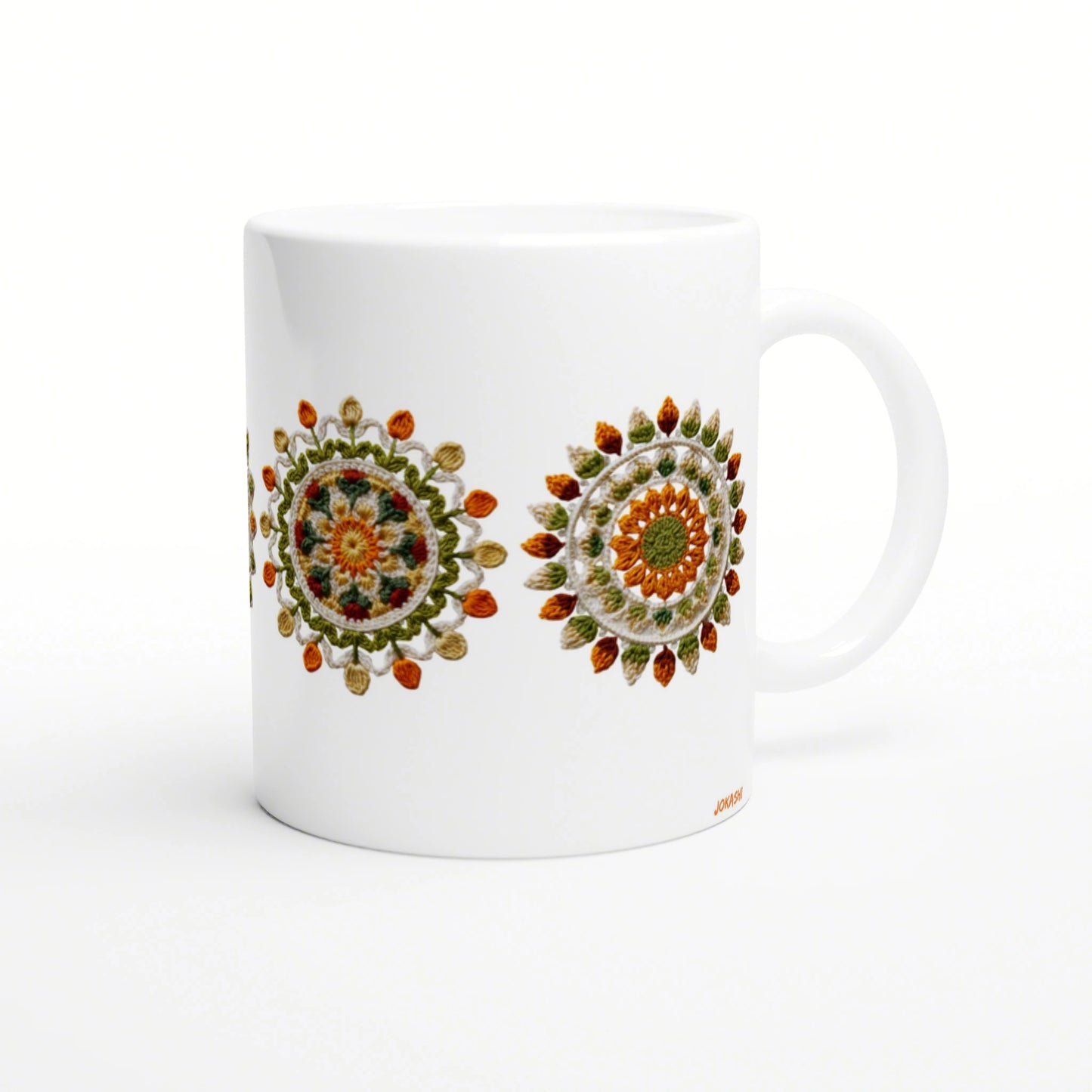 White ceramic mug mockup featuring two colorful crochet mandala designs in orange, green and yellow.