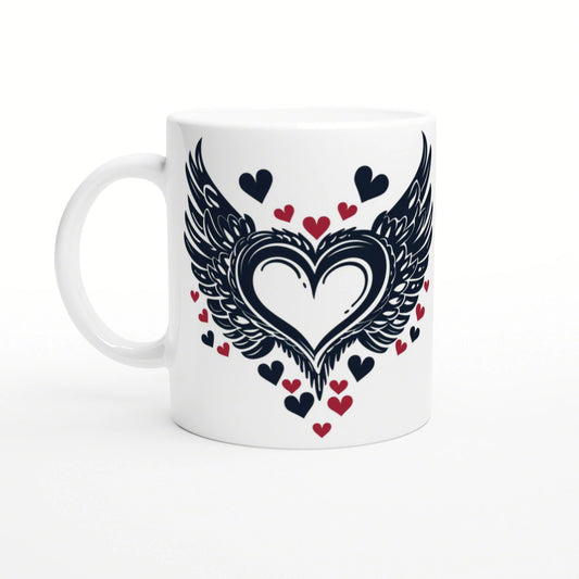 White ceramic mug with a large dark winged heart design, flanked by black and red small hearts.