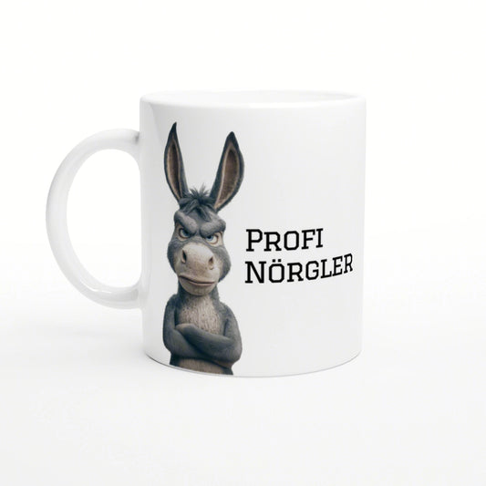 White mug featuring a grumpy cartoon donkey with crossed arms and the text PROFI NÖRGLER.