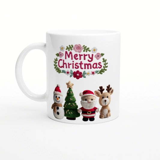 White mug with knitted Christmas design: Merry Christmas in a floral wreath, plus snowman, Christmas tree, Santa, reindeer.