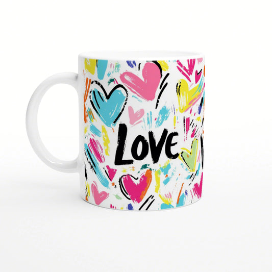 Product mockup: white mug with colorful abstract hearts and brush strokes surrounding the bold black word 'Love'.