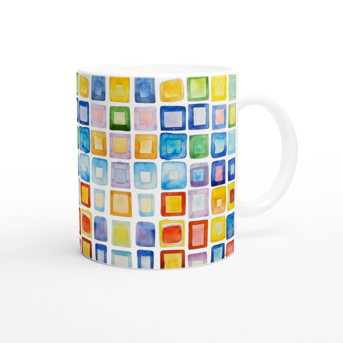 White ceramic mug with a vibrant grid of multicolored watercolor squares wrapping around its surface.