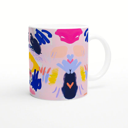 Abstract colorful mug with brushstroke patterns and heart shapes; product mockup.