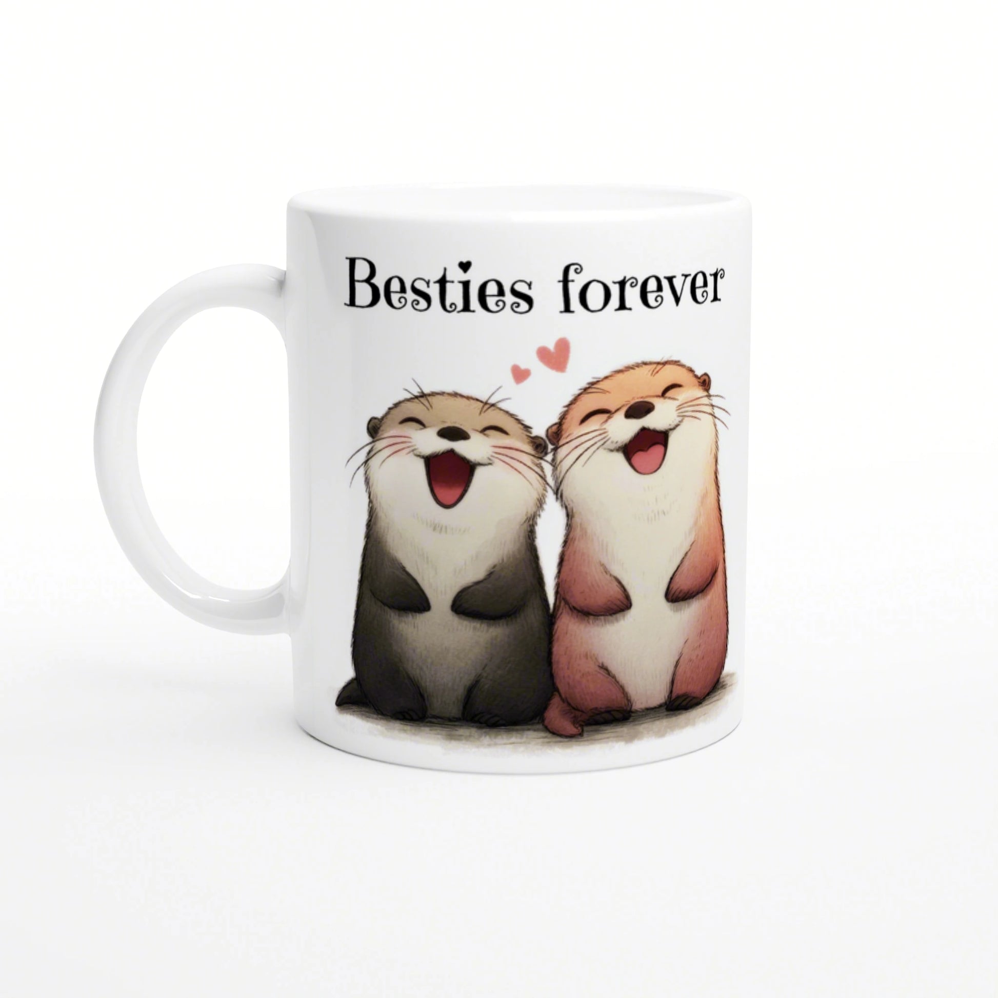 White ceramic mug featuring two smiling cartoon otters side by side, with the caption 'Besties forever' and small pink hearts.