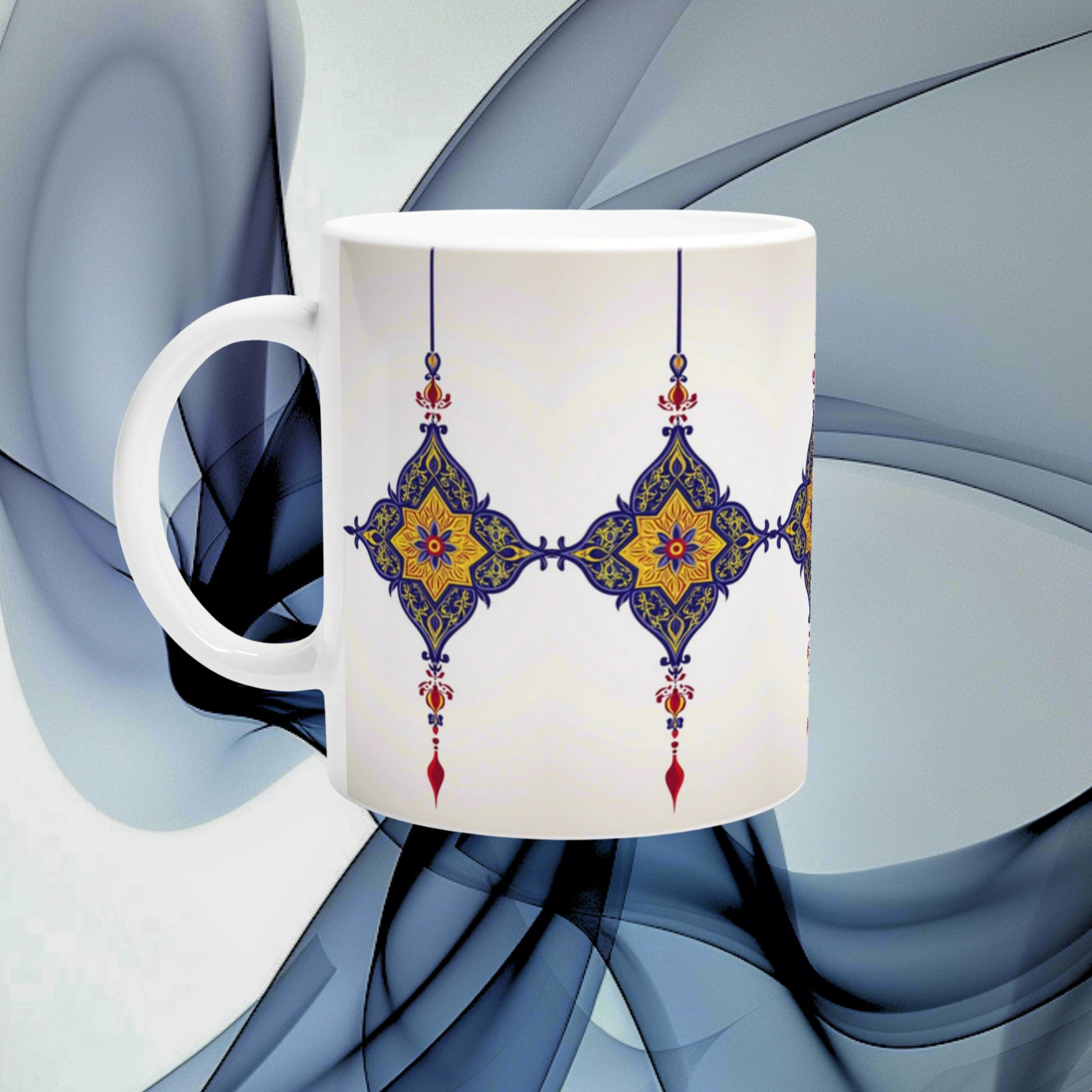 Product mug mockup: white ceramic mug with blue-gold ornate pattern wrapping around, set against abstract blue background.