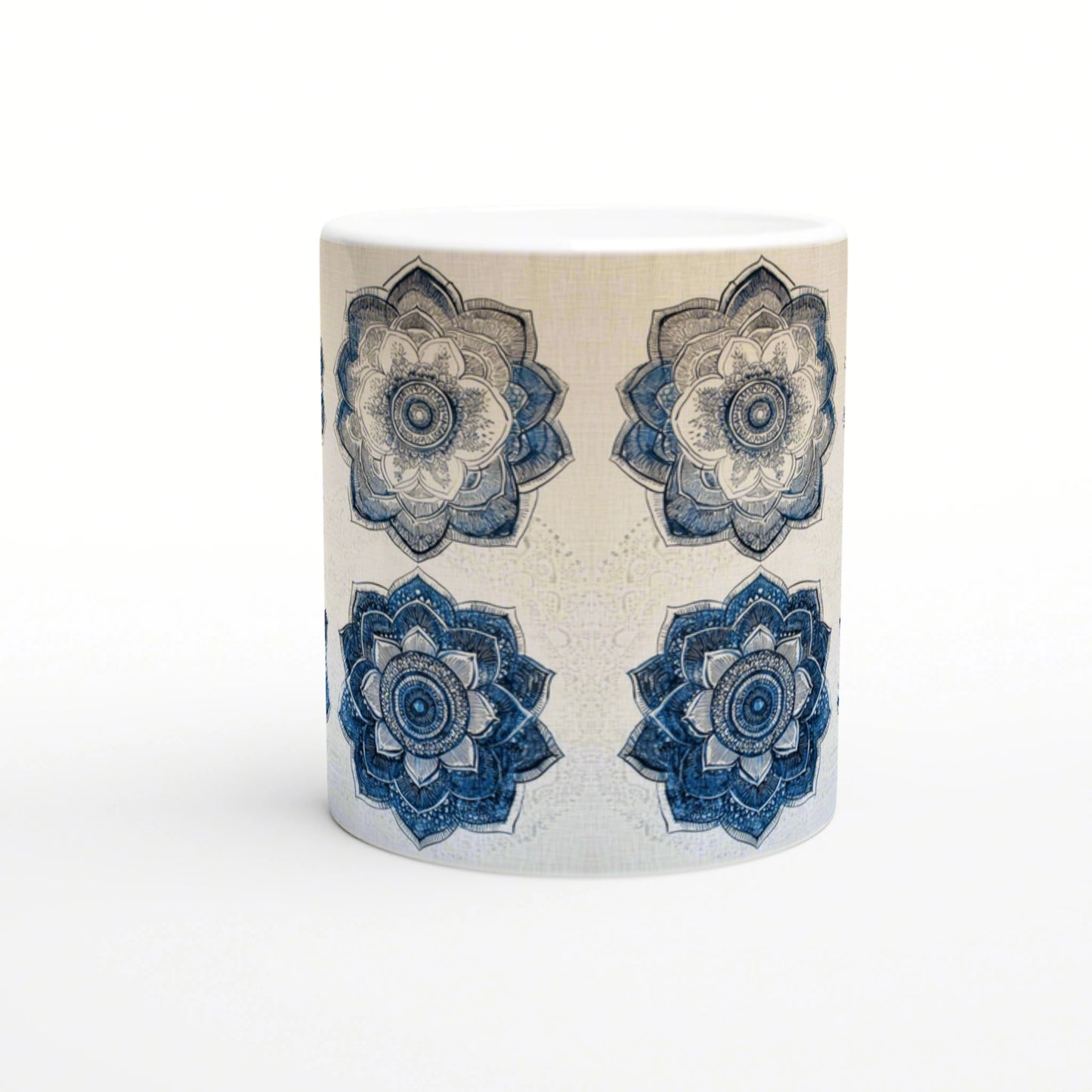 Ceramic mug mockup: white mug with a beige textured background and four blue mandala flowers around its body.