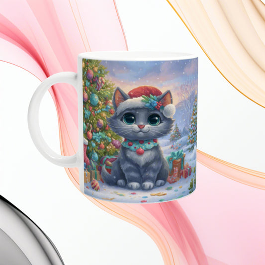 Ceramic mug featuring a cute gray kitten in a Santa hat in a snowy Christmas scene with a decorated tree.