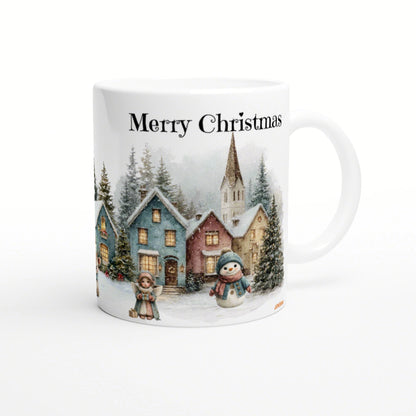 Ceramic mug mockup with festive winter scene: colorful cottages, snow, a snowman, a child, and the text Merry Christmas.