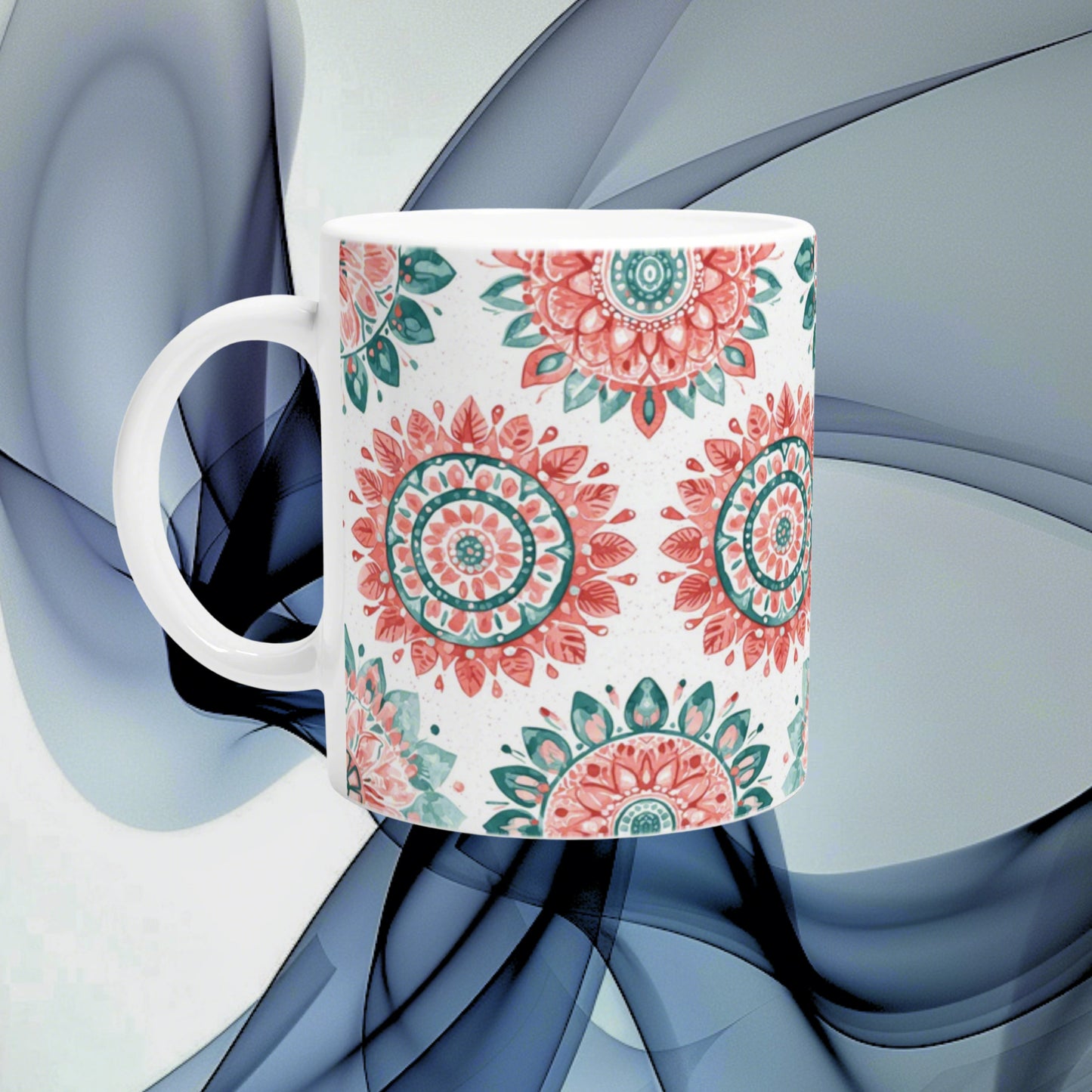 Ceramic mug with pink and teal mandala patterns on white, shown as an online shop product mockup.