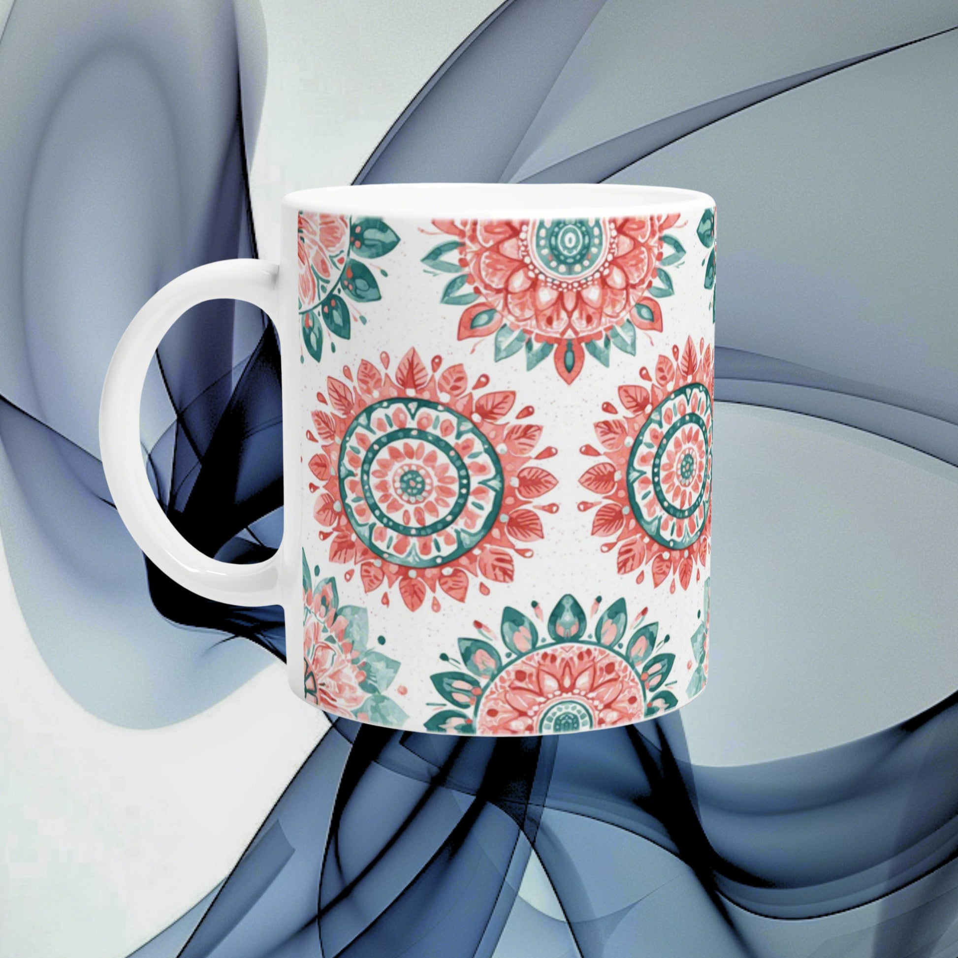 Ceramic mug with pink and teal mandala patterns on white, shown as an online shop product mockup.