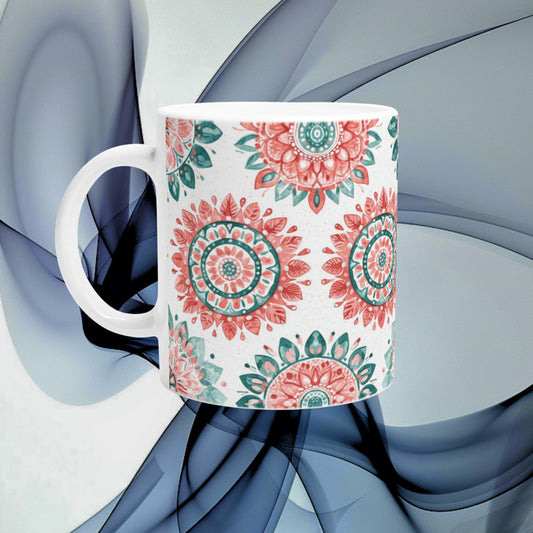 Ceramic mug with pink and teal mandala patterns on white, shown as an online shop product mockup.