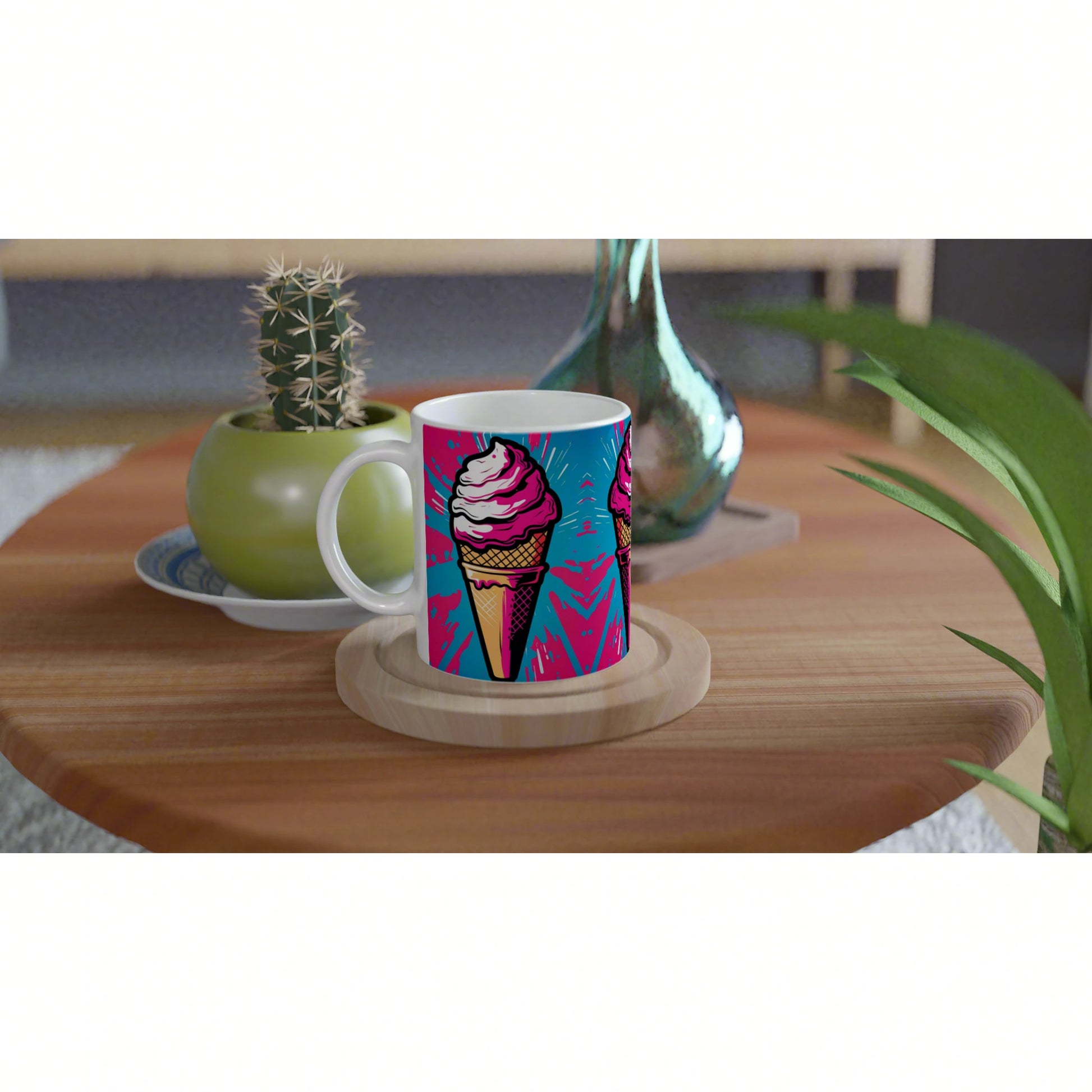 Colorful mug featuring a pink ice-cream cone on blue, on a wooden coaster beside a cactus and a glass vase.