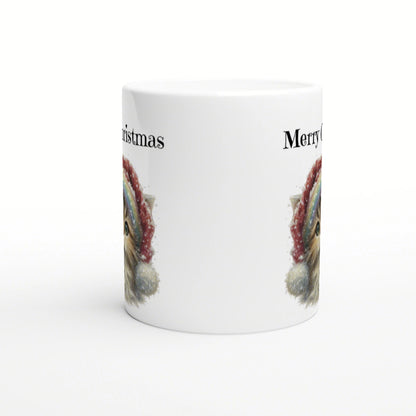 White ceramic mug with a wraparound festive design: a partial furry animal face in a Santa hat and Merry Christmas text.