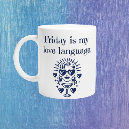 White mug with navy text Friday is my love language and a retro figure with heart sunglasses and a cocktail, on a blue background.