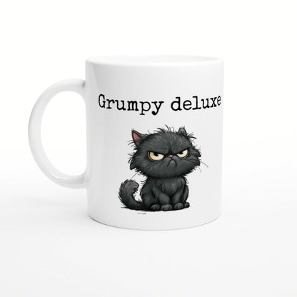 Product mockup: white ceramic mug featuring a grumpy cartoon black cat and the text Grumpy deluxe.
