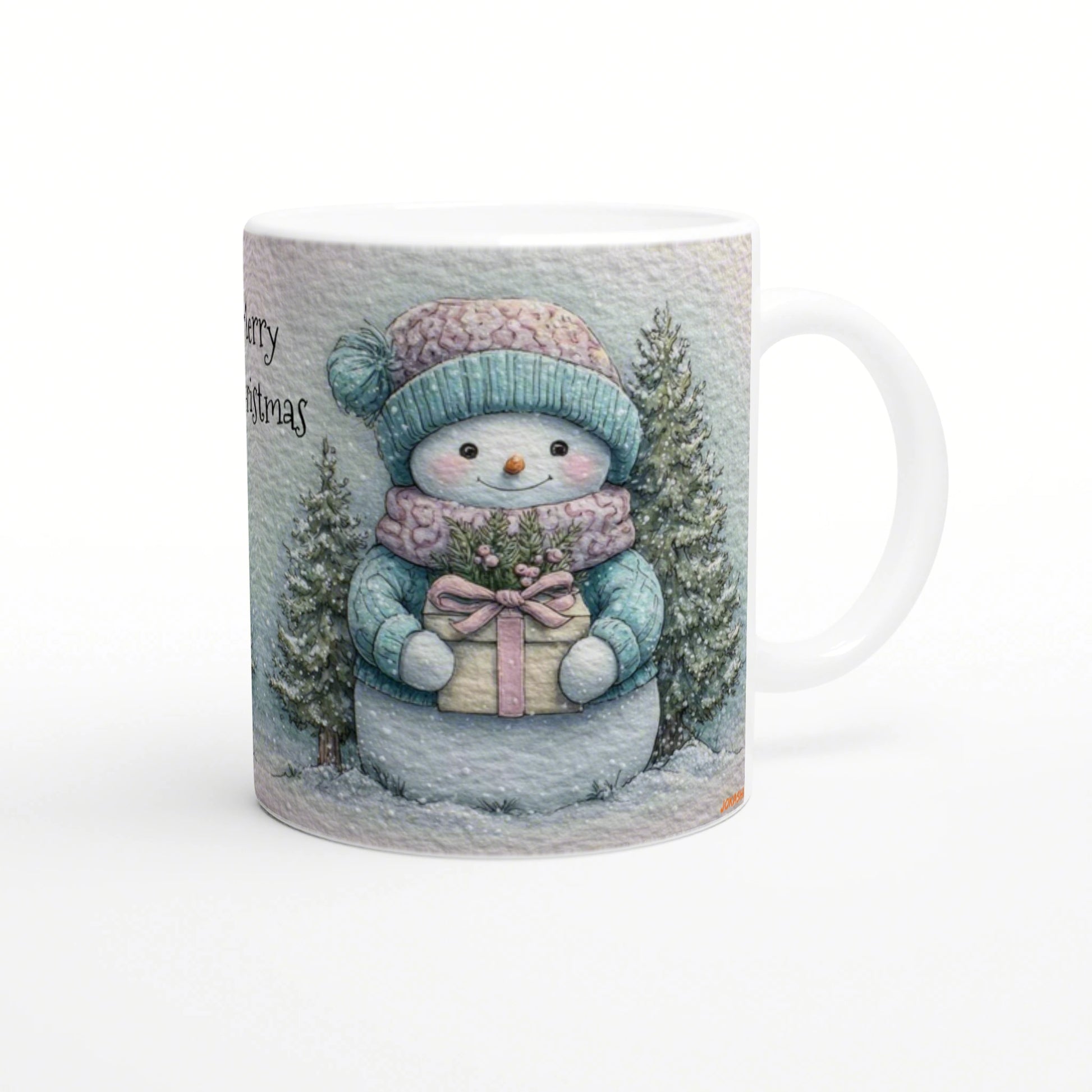 Illustrated mug with a smiling snowman in a teal knit hat and scarf, holding a wrapped gift among snowy evergreens and partial 'Merry Christmas' text.