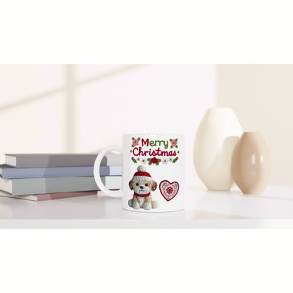 Product mockup: white mug featuring a 'Merry Christmas' design with a cute dog in a red Santa hat, heart motif, shown beside books and decorative vases.