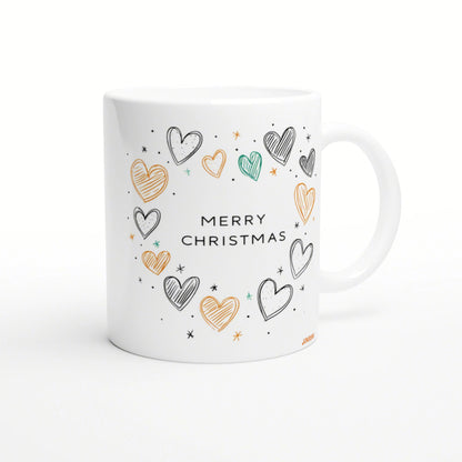 White mug mockup with 'MERRY CHRISTMAS' text surrounded by colorful hand-drawn hearts and stars in orange, teal, and black.