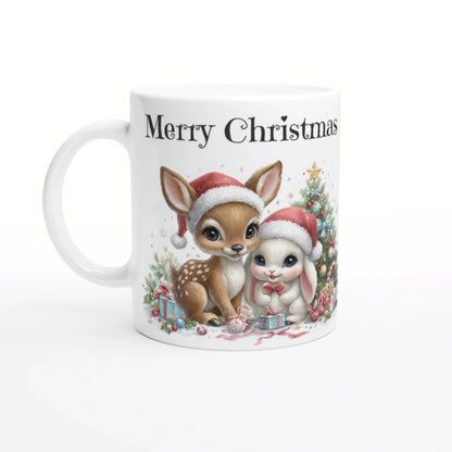White ceramic mug with Merry Christmas featuring a deer and a bunny in Santa hats beside a Christmas tree.
