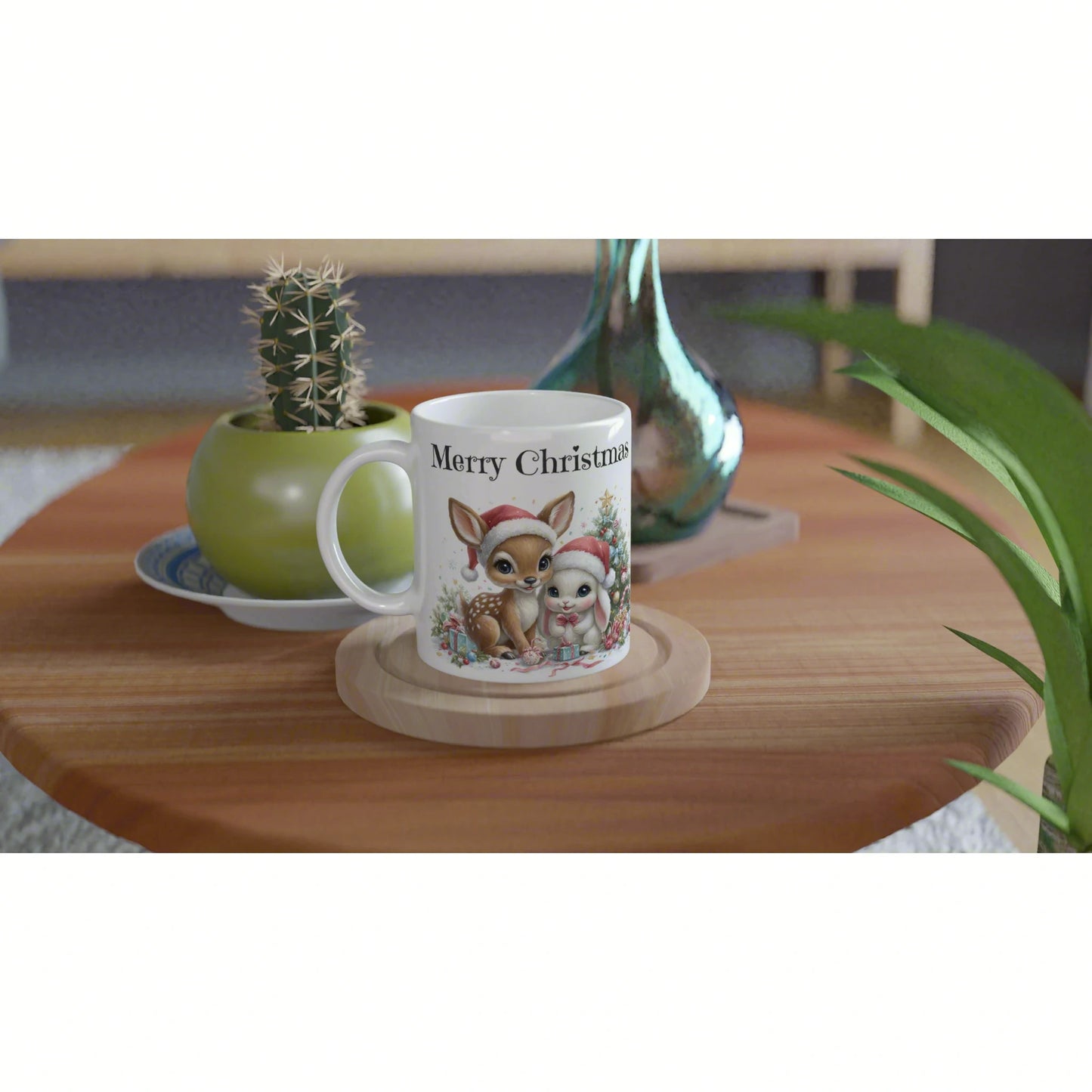 White mug with 'Merry Christmas' featuring a deer and bunny in Santa hats on a wooden table with plants in the background.