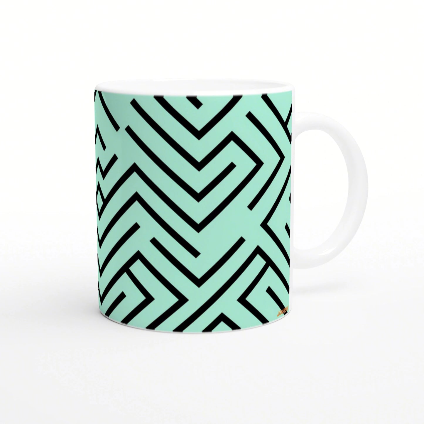 Mug with mint-green surface featuring a bold black geometric maze pattern wrapping around.