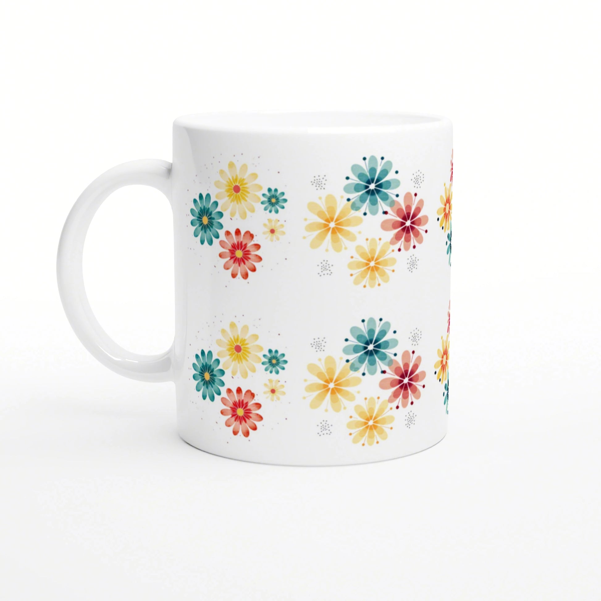 Product mockup: white ceramic mug adorned with scattered colorful flowers in yellow, teal, orange and red on a white background.