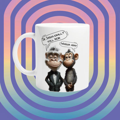 Mockup white mug showing two cartoon monkeys in tuxedos with German speech bubbles, on a retro rainbow background.