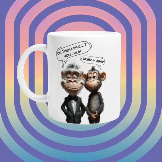 Mockup white mug showing two cartoon monkeys in tuxedos with German speech bubbles, on a retro rainbow background.