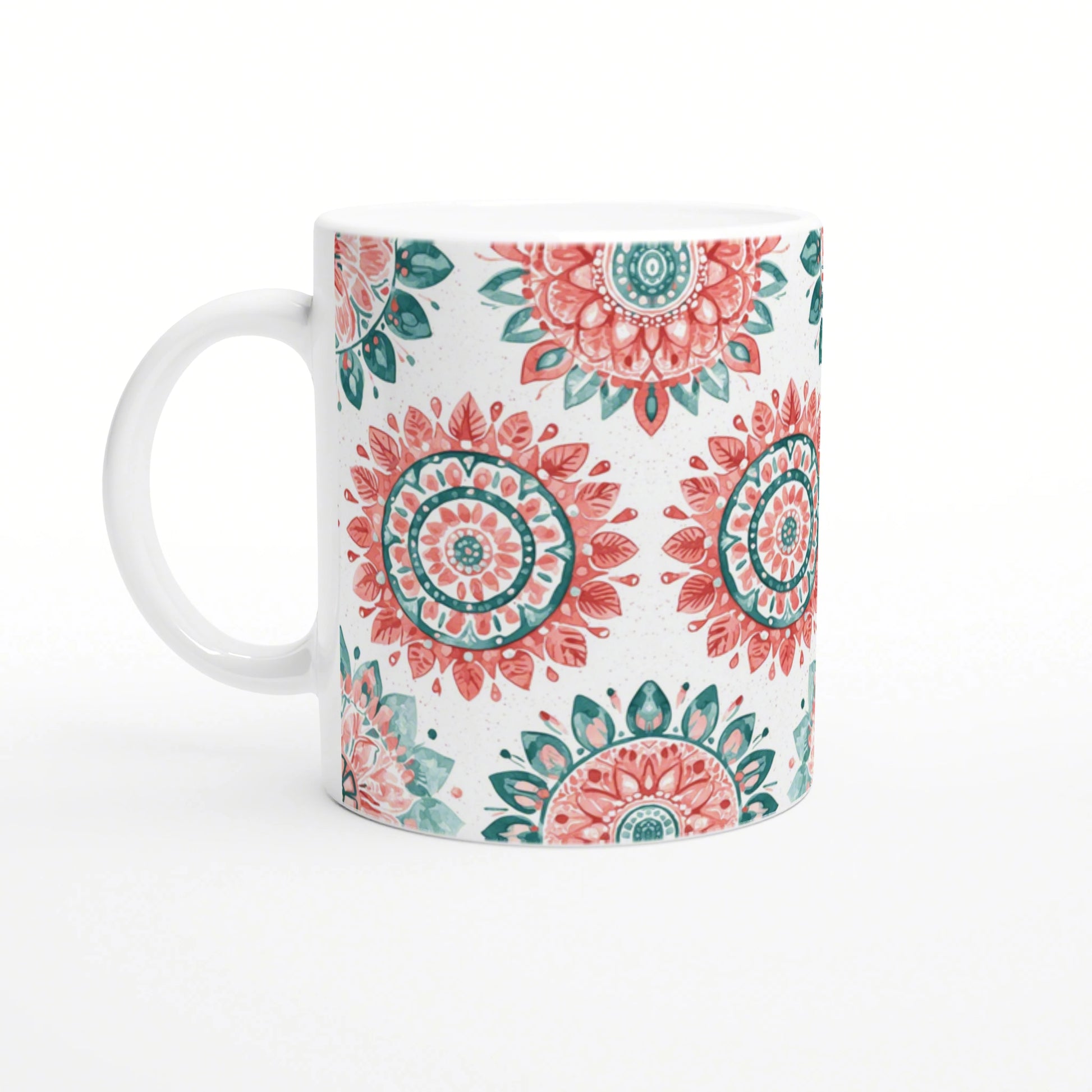 White ceramic mug with coral-pink and teal mandala patterns on a white background; product mockup for a cup in an online shop.