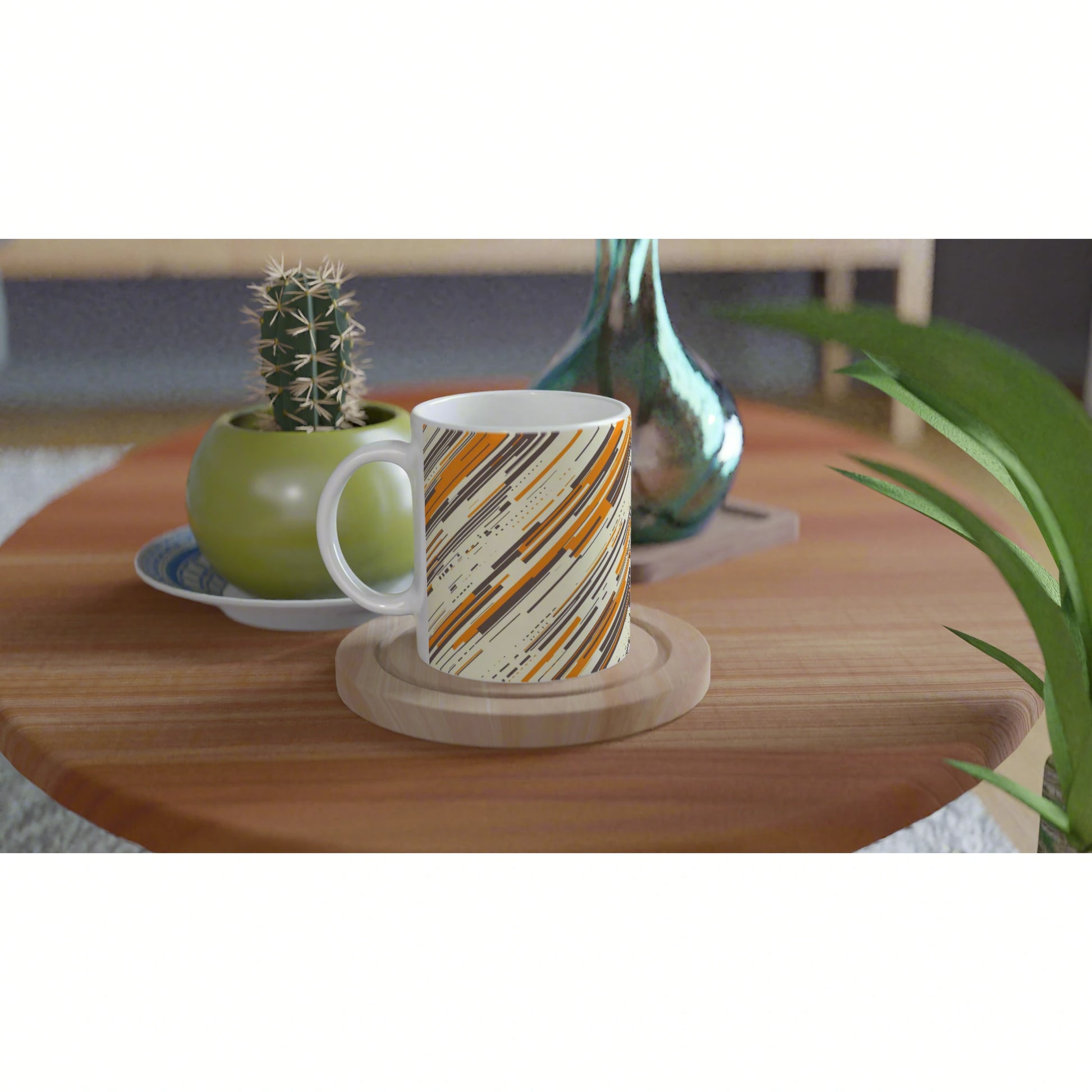 Product mockup: mug with orange, black and gray diagonal stripes on a wooden coaster, on a table with cactus and teal vase.