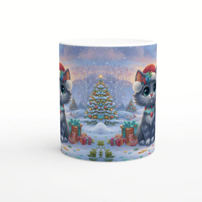 Mug mockup showing two gray cats in Santa hats beside a decorated Christmas tree and gifts in a snowy holiday scene.