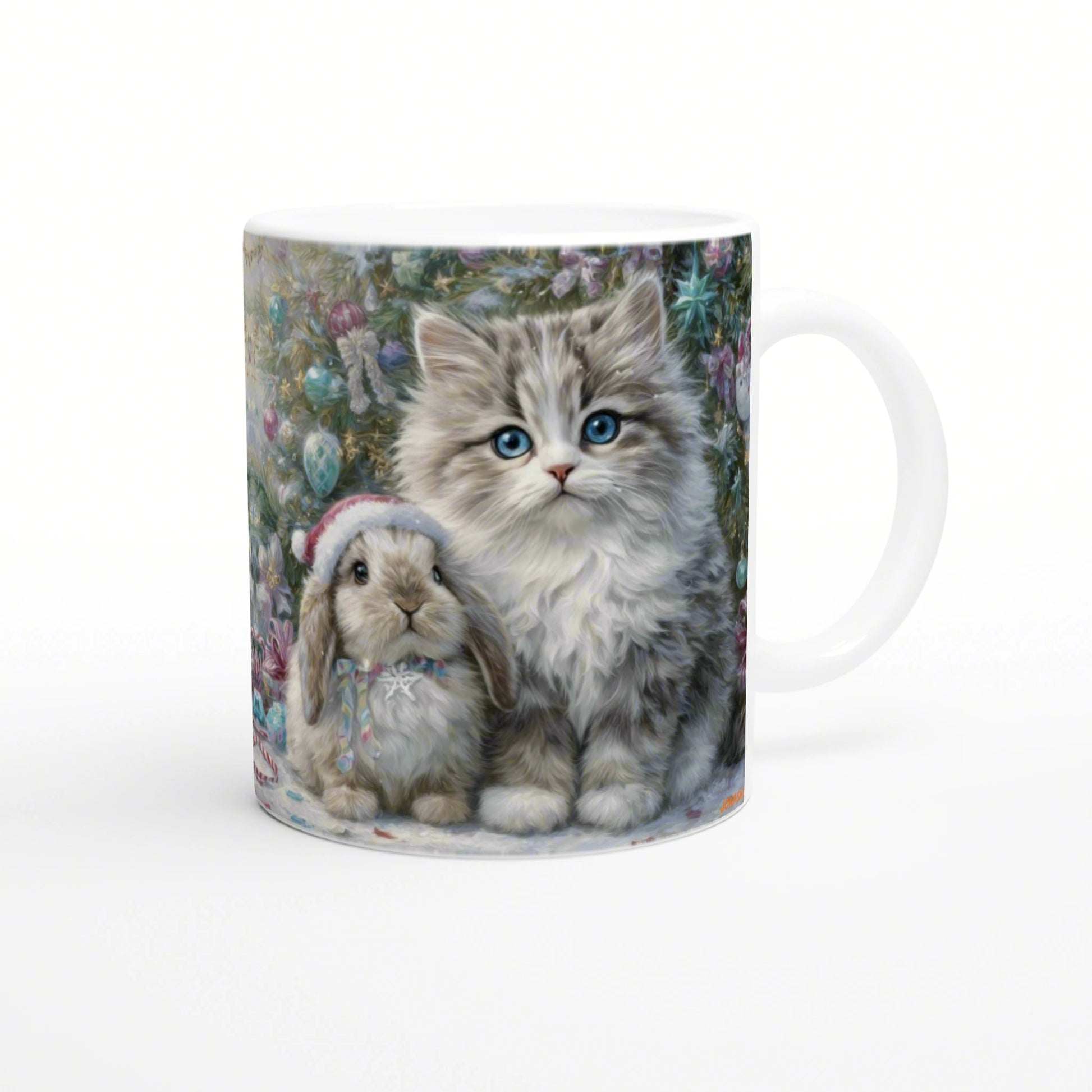Mug featuring a festive illustration of a fluffy kitten with blue eyes and a bunny wearing a Santa hat in front of a decorated Christmas tree.