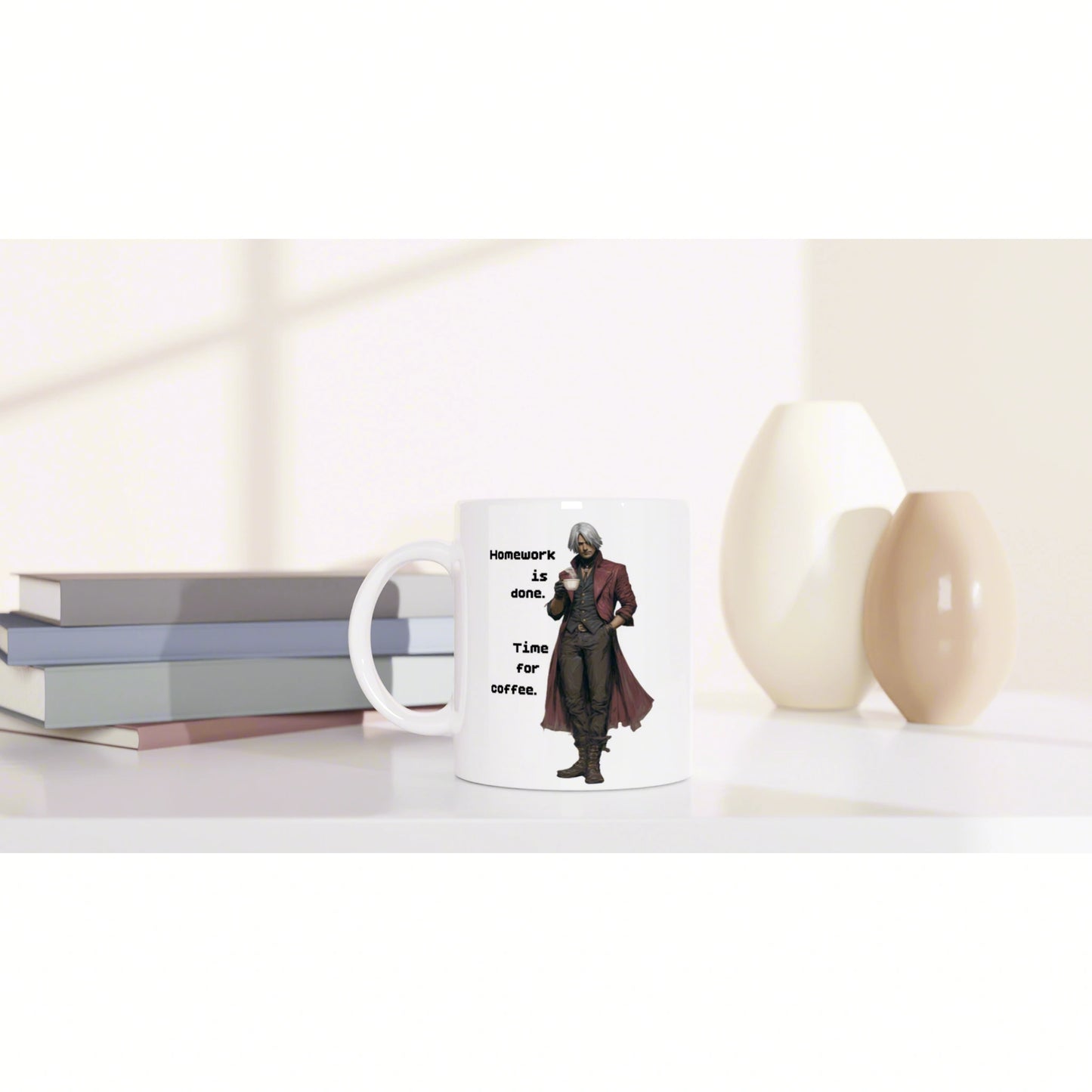 White mug with illustrated character and caption Homework is done. Time for coffee, on a desk with books and vases.