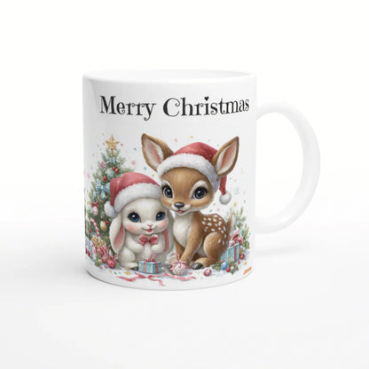 White mug featuring 'Merry Christmas' with a cute fawn and bunny in Santa hats, beside a festive Christmas tree and presents.