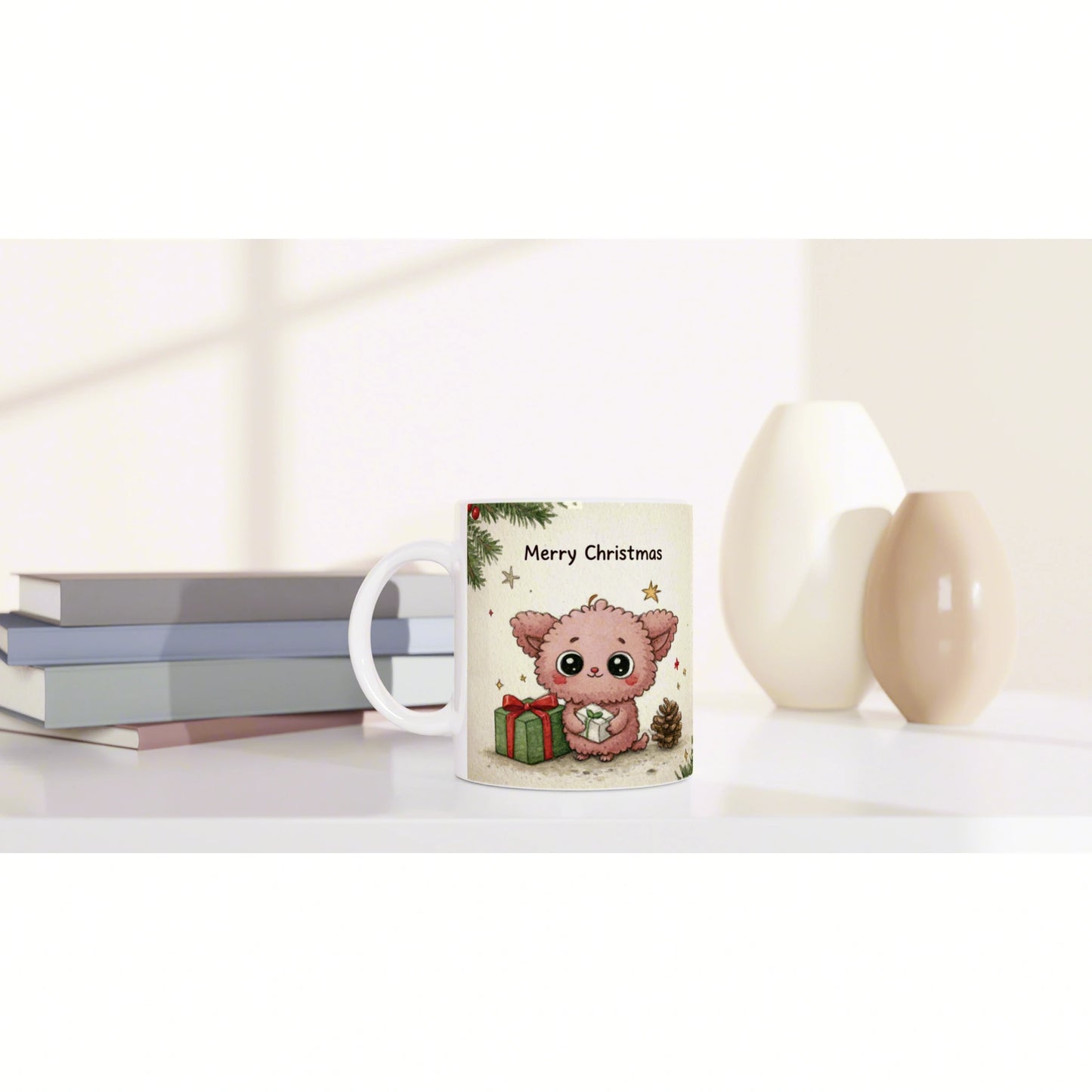 Mug mockup: white mug with 'Merry Christmas' and a pink cartoon animal with gifts, beside books and neutral vases.