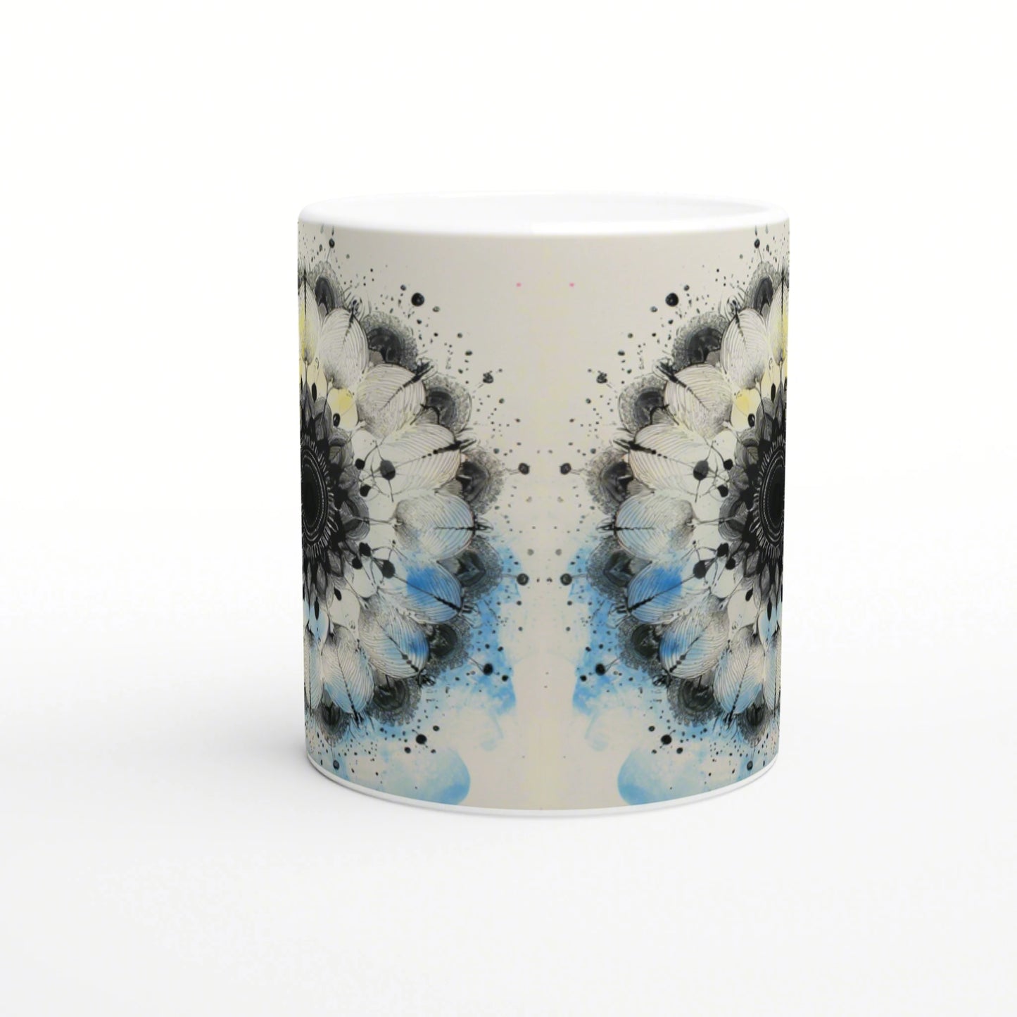 Mug mockup featuring a symmetrical black-and-white mandala floral pattern with blue watercolor splashes.