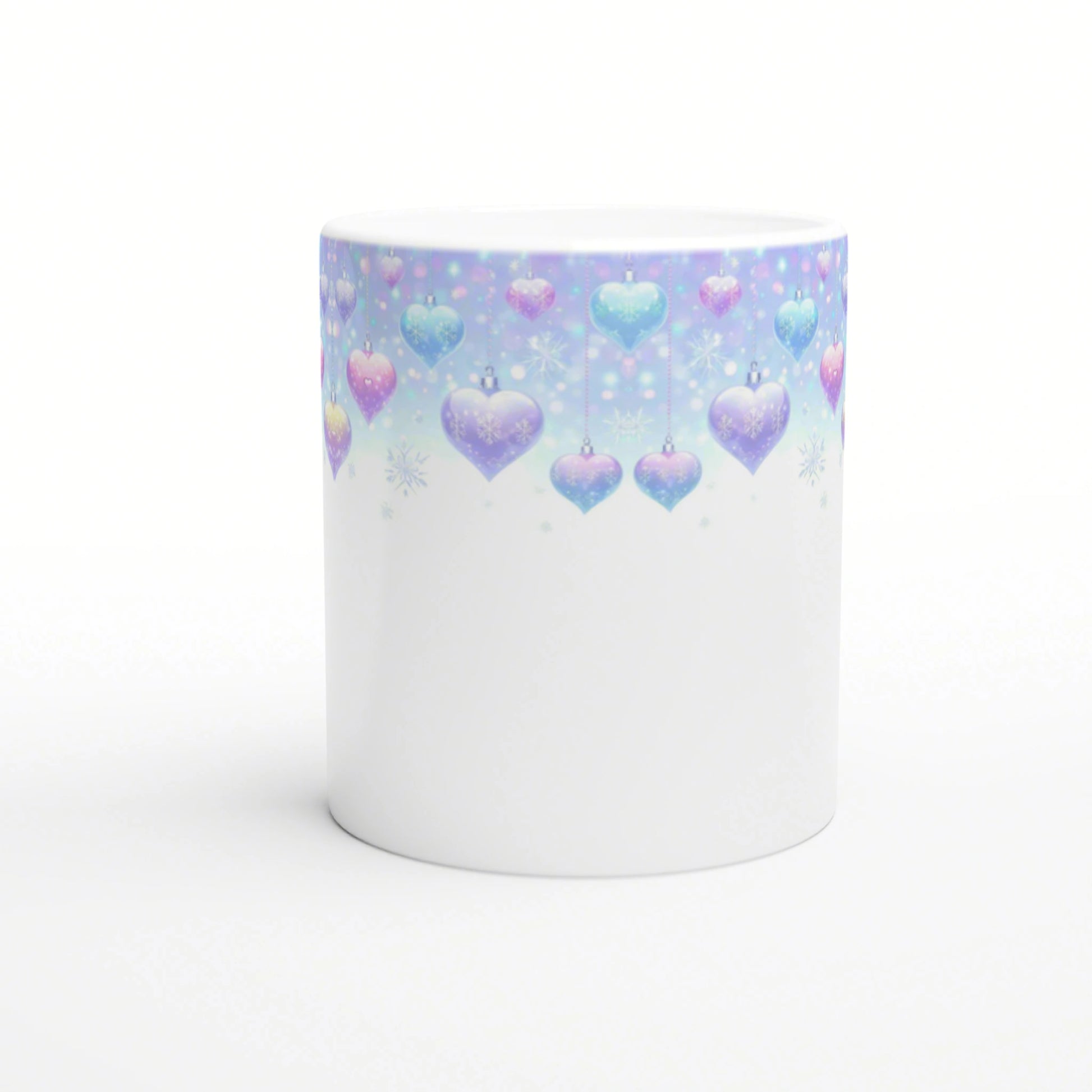 Product mockup: white ceramic mug with pastel gradient top featuring hanging blue and pink heart ornaments and snowflakes.