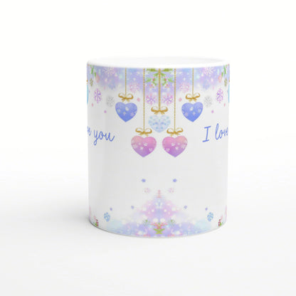 Product mug with pastel holiday pattern: hanging heart ornaments, snowflakes, and 'I love you' text on white background.