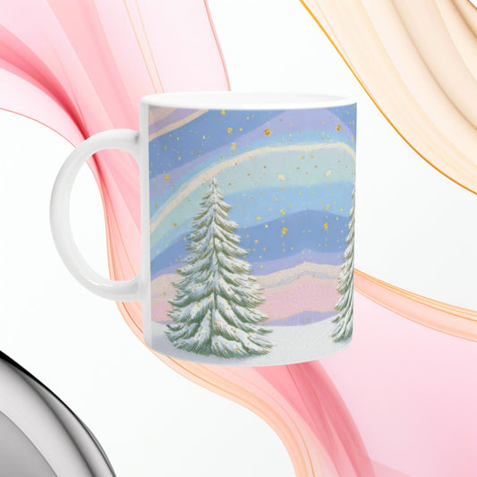 Product mug mockup showing a pastel winter landscape with snow-covered pine trees, blue-pink hills, and gold specks in the sky.