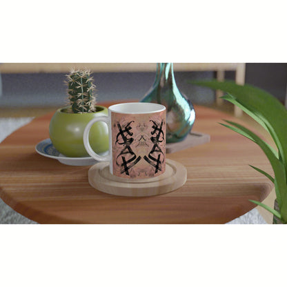 Product mug mockup on a wooden table: pink patterned mug with a black abstract motif, cactus and green vase in the background