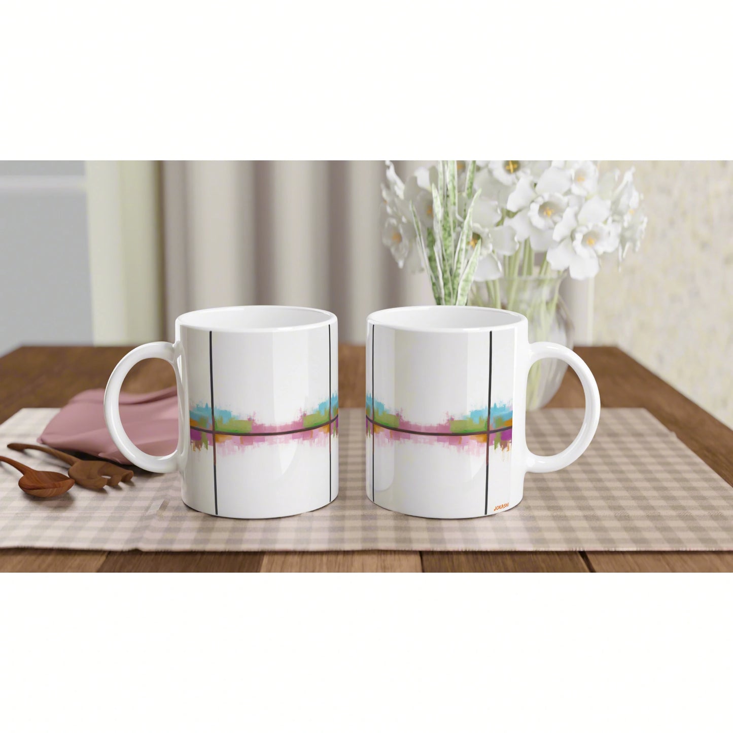 Product mockup: two white ceramic mugs with a colorful abstract stripe design, placed side by side on a wooden table.