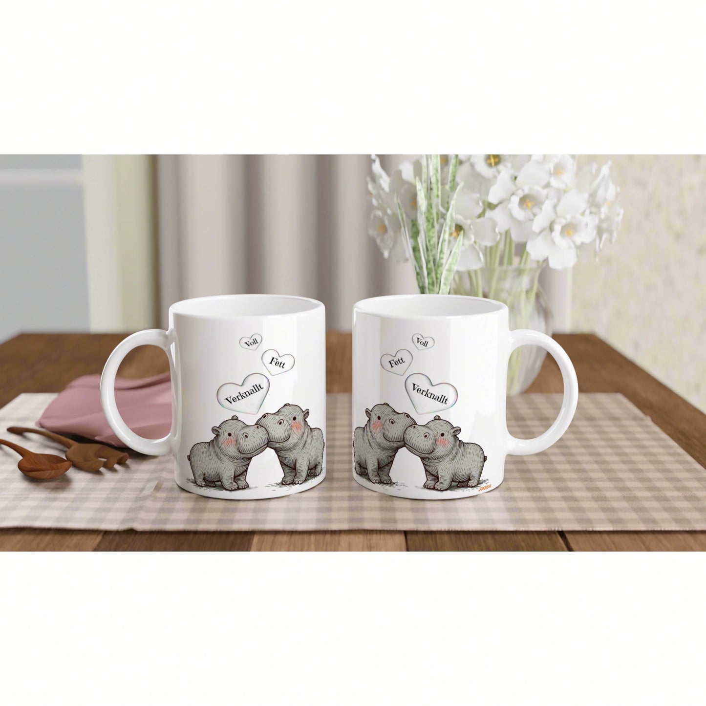 Product mockup: two white mugs featuring cartoon hippos kissing with hearts on a wooden table.