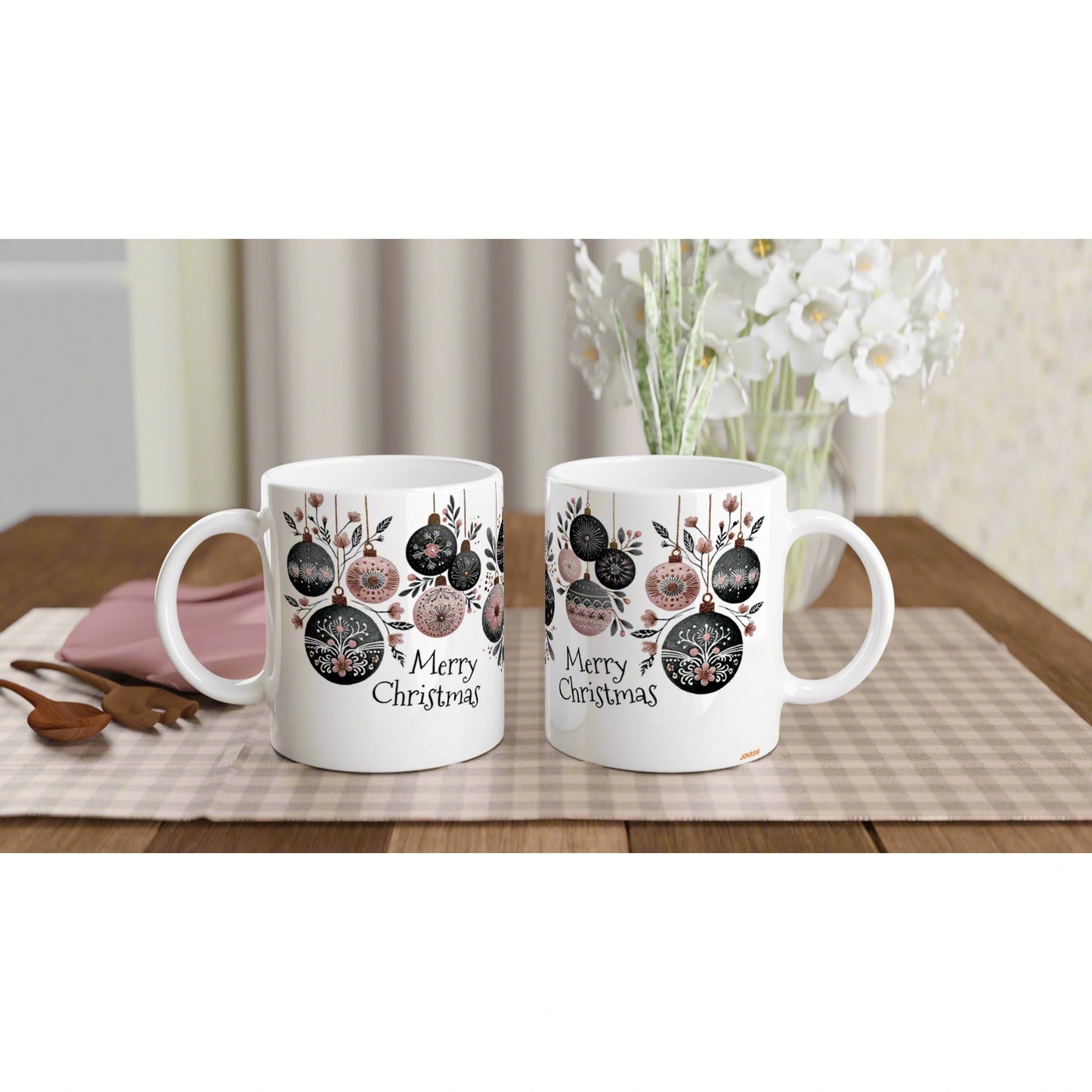 Product mockup: two white mugs with festive ornament designs and 'Merry Christmas' text on a wooden table.