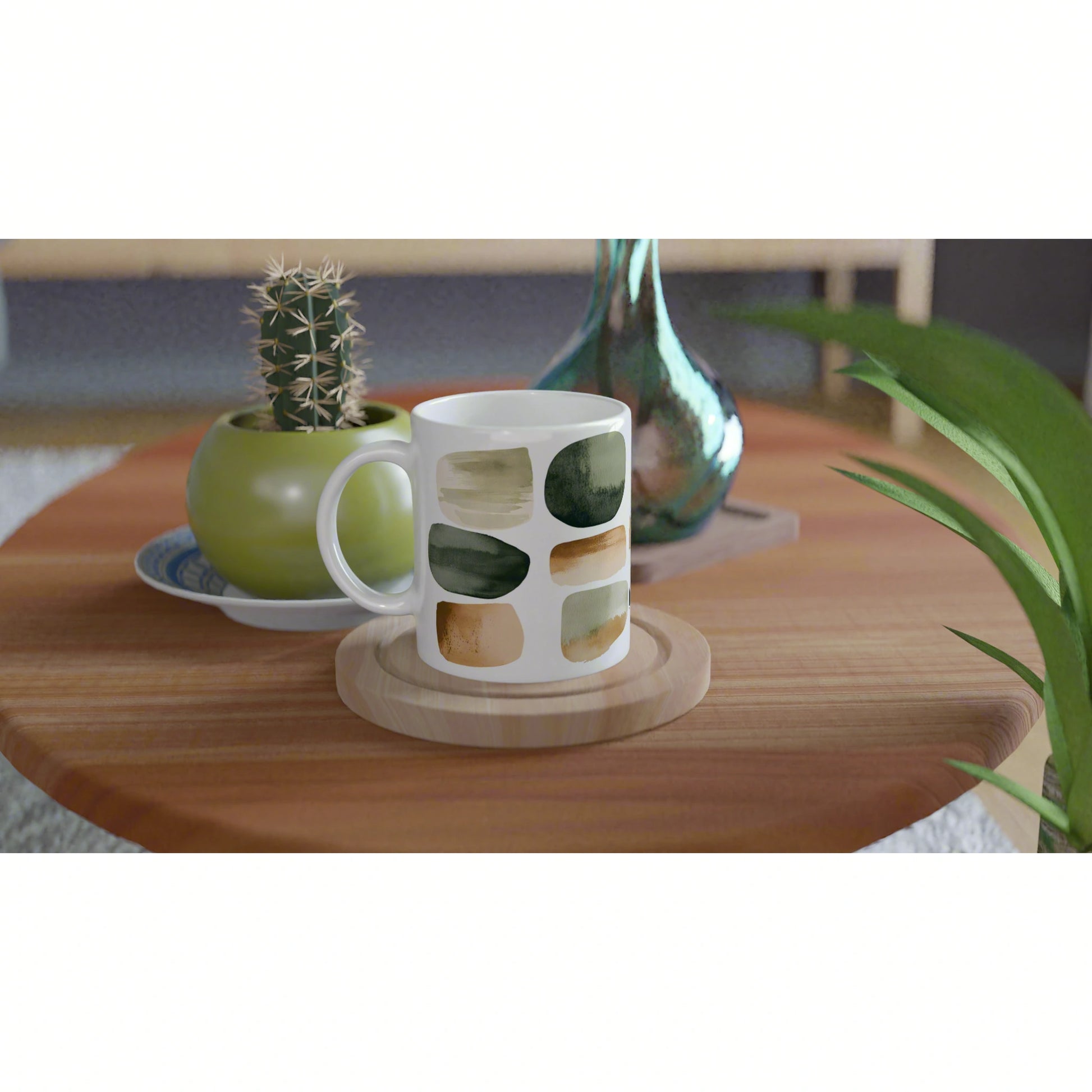 Product mockup: white ceramic mug with abstract green and brown brushstrokes on a wooden table.