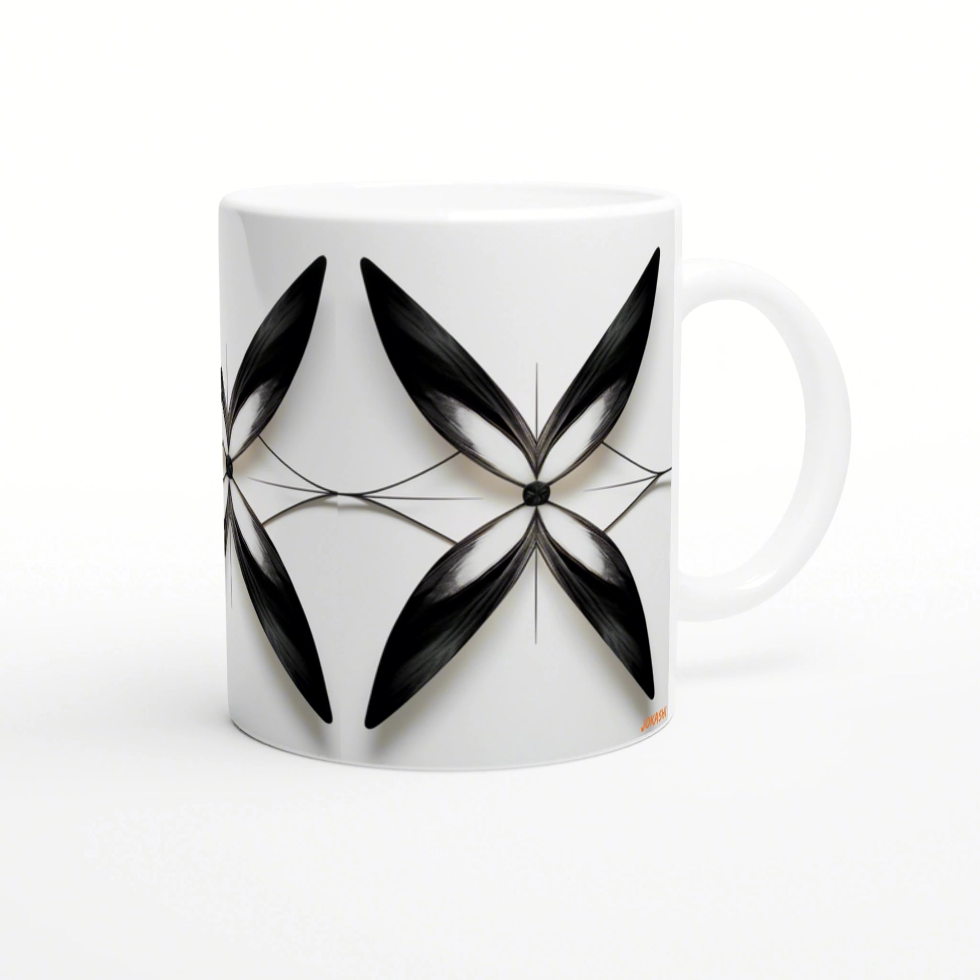 Product mockup: white ceramic mug featuring an abstract black leaf motif in a geometric crossing-petal design.