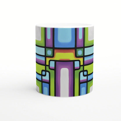 Product mockup: white mug with bright abstract geometric pattern and bold black outlines in blue, green, purple, and yellow.